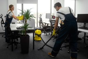 two people professionally cleaning the office